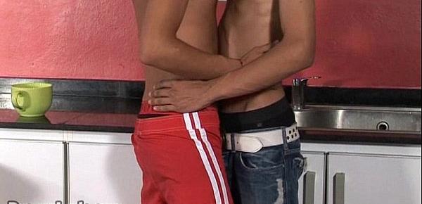  Passionate twinks kiss and go down in the kitchen